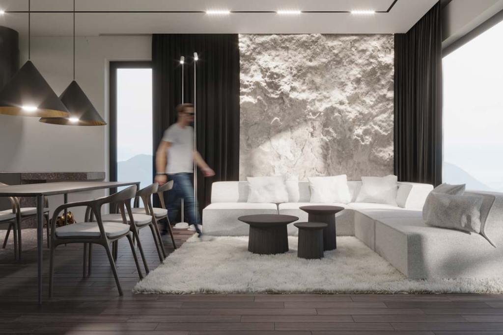 salon z kamienistą ścianą, faktury, miękki dywan, trendy 2025 we wnętrzach